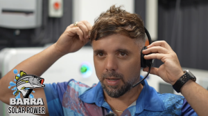Laurence with Headset on and Barra solar power logo in bottom left corner.